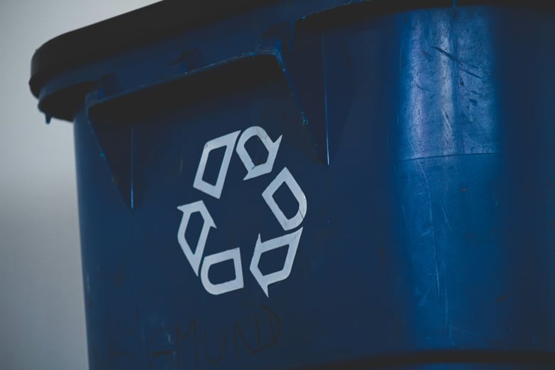 A recycling symbol on a blue bin for Global Recycling Day